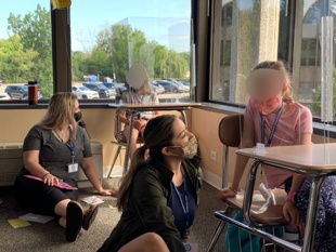 Counselor and camper with plexiglass between